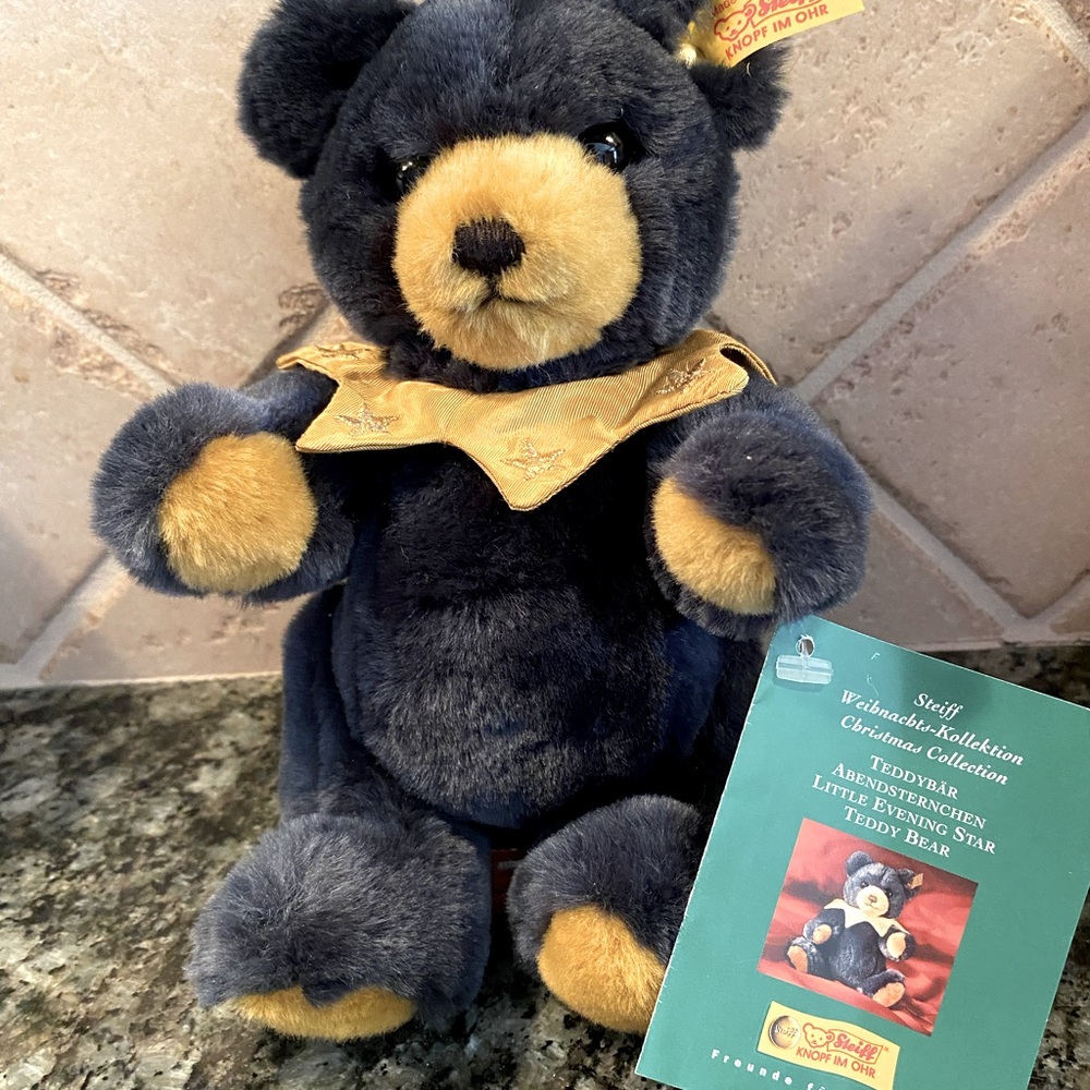 Steiff “Little Evening Star Teddy Bear Number 671012”, 9” standing, dark blue.